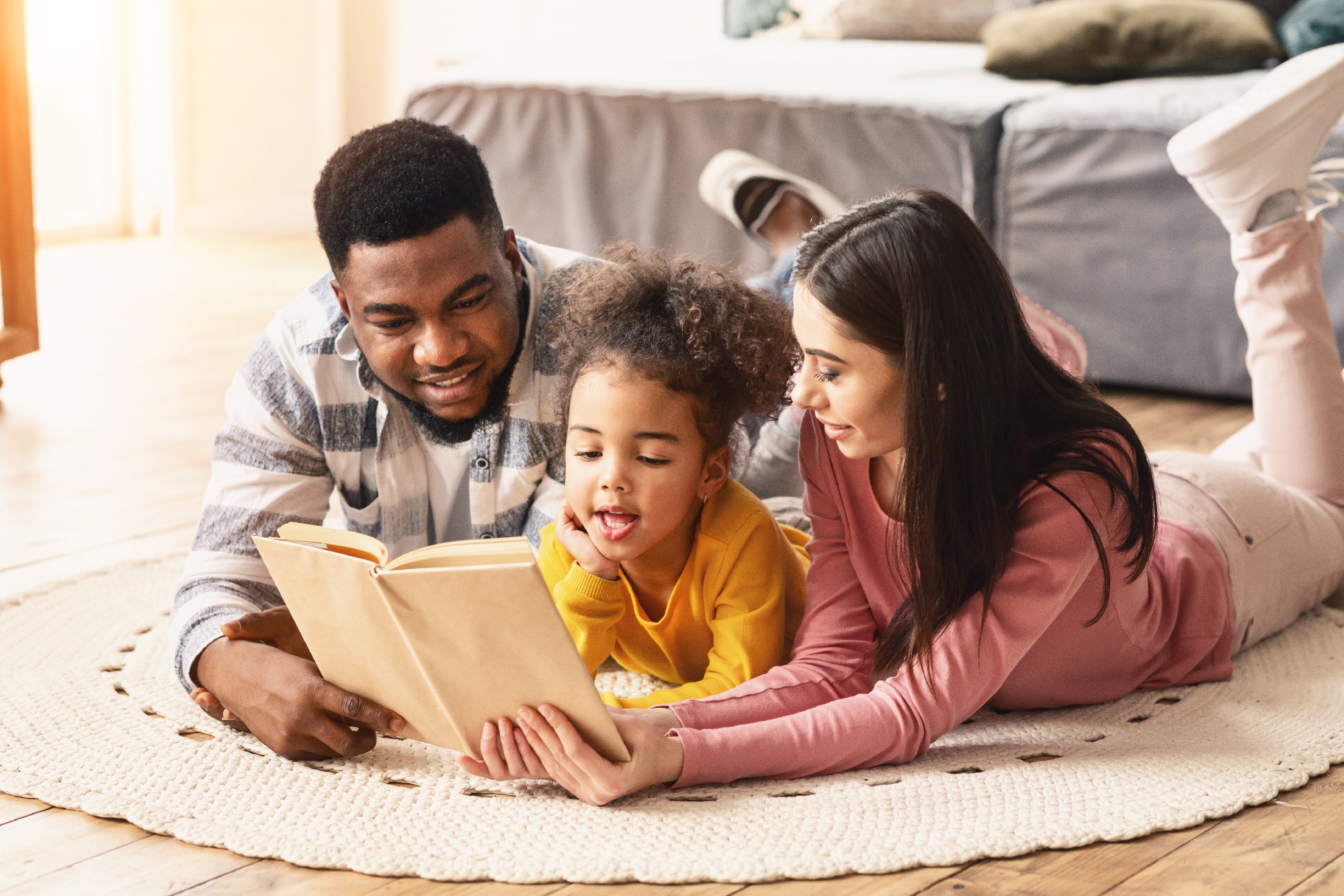 Parents reading book to daughter using SEL program curriculm