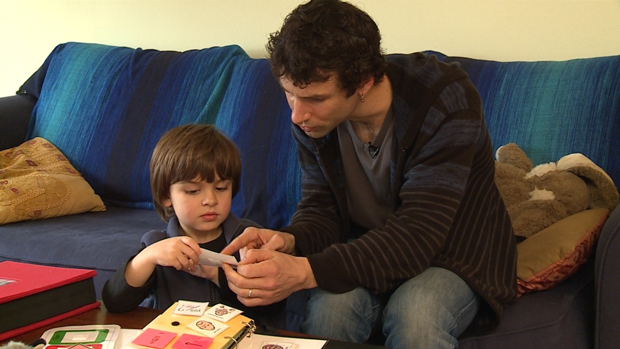 father and son looking at cue cards